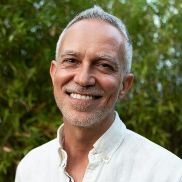 Horizontal headshot of smiling white man in nature.